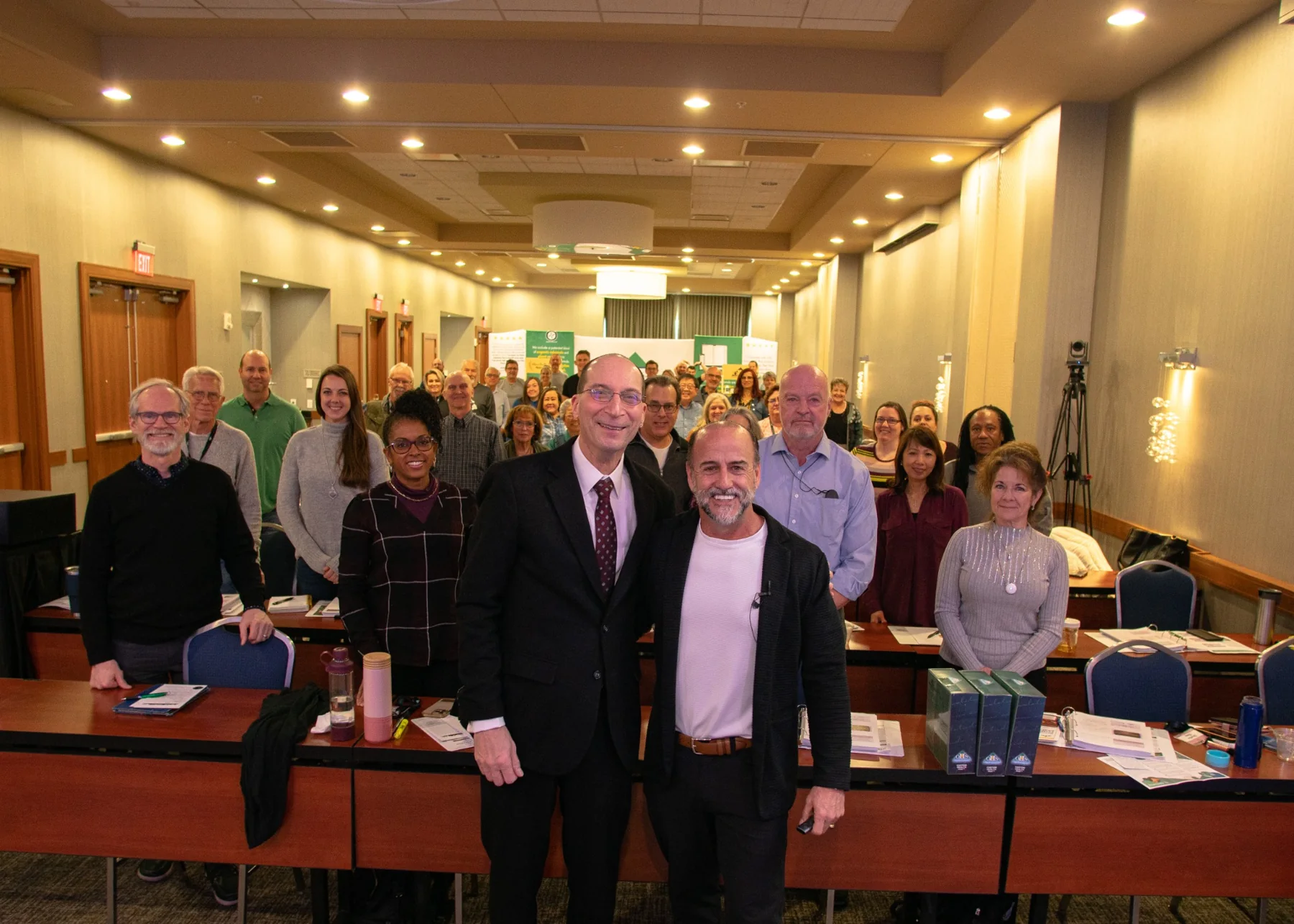 Group of conference attendees gathered in a professional training room after a session